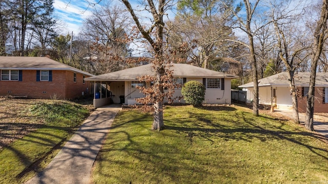 single story home featuring a front lawn and a carport