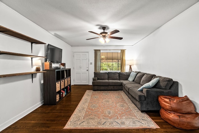 living room featuring ceiling fan, dark wood-type flooring, and a textured ceiling