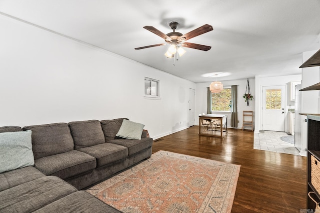 living room with dark wood-type flooring and ceiling fan