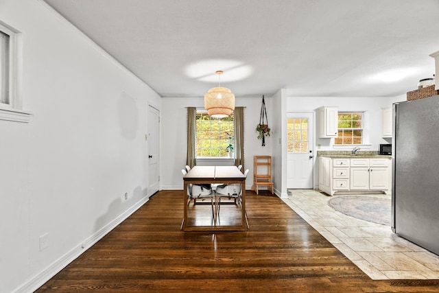 dining space with plenty of natural light, sink, and hardwood / wood-style floors