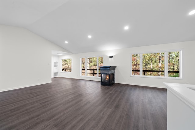 unfurnished living room featuring dark hardwood / wood-style flooring and vaulted ceiling