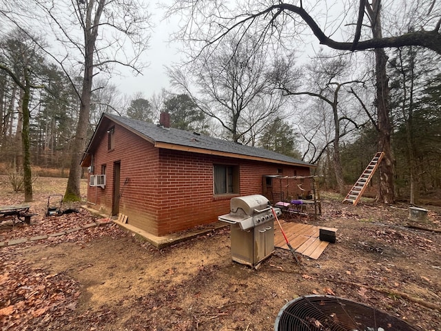 view of side of home with cooling unit and a deck