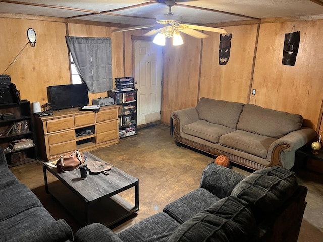 living room featuring ceiling fan, concrete floors, and wood walls