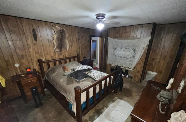 bedroom with wooden walls and ceiling fan