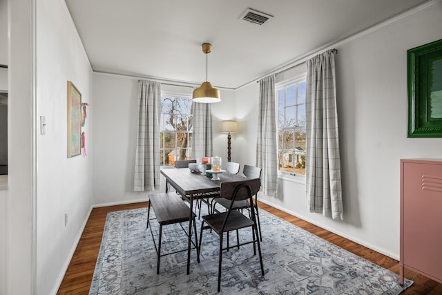 dining area with hardwood / wood-style floors and a healthy amount of sunlight