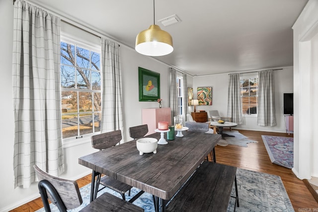 dining space featuring dark hardwood / wood-style flooring