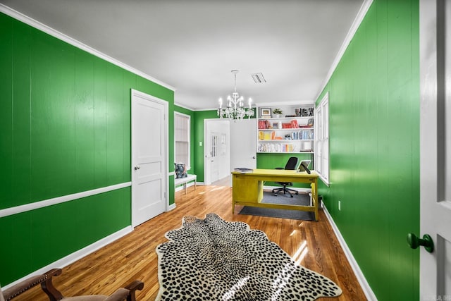 game room with crown molding, a chandelier, and hardwood / wood-style flooring