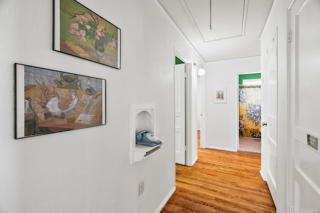 corridor with hardwood / wood-style flooring