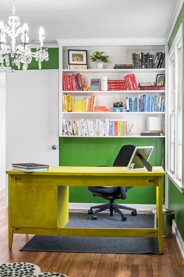 office featuring wood-type flooring, an inviting chandelier, and crown molding