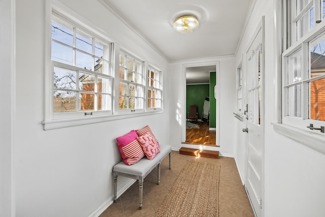 corridor featuring crown molding and light tile patterned flooring