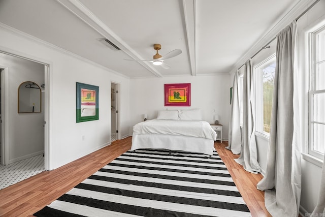 bedroom featuring beamed ceiling, ceiling fan, and light wood-type flooring