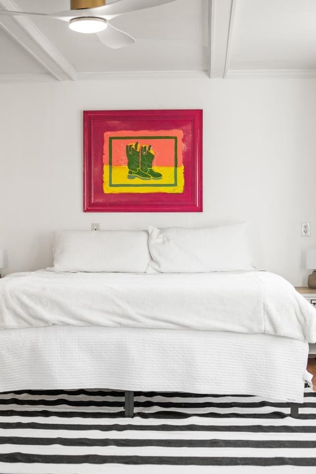 bedroom featuring ornamental molding and beam ceiling