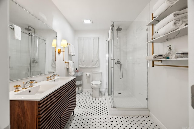 bathroom with vanity, an enclosed shower, and toilet