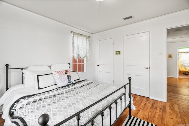 bedroom with hardwood / wood-style floors