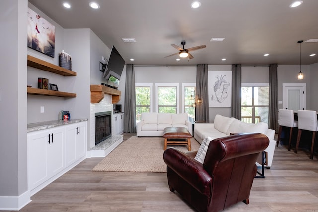 living room featuring ceiling fan and light wood-type flooring