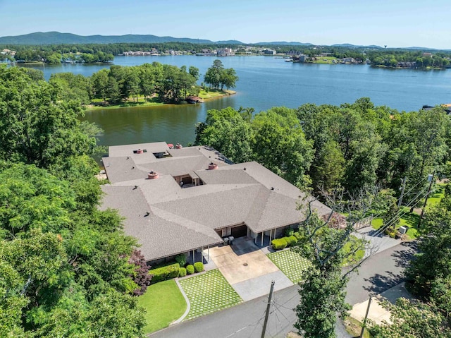 birds eye view of property with a water and mountain view