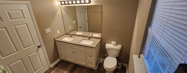 bathroom featuring vanity, wood-type flooring, and toilet