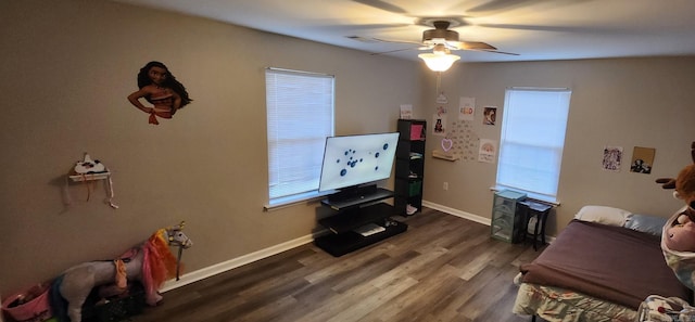 sitting room with ceiling fan and dark hardwood / wood-style floors