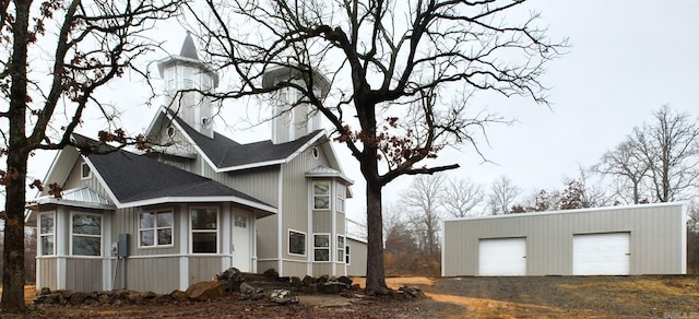 view of side of home featuring an outbuilding and a garage