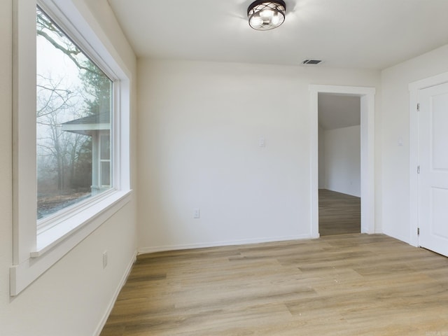 empty room with a healthy amount of sunlight and light wood-type flooring