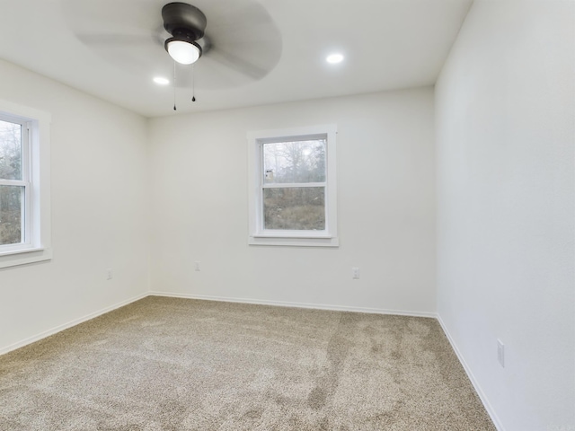 unfurnished room with ceiling fan and carpet flooring