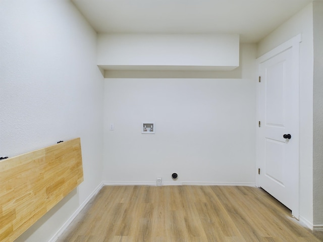 laundry room featuring washer hookup and light hardwood / wood-style floors