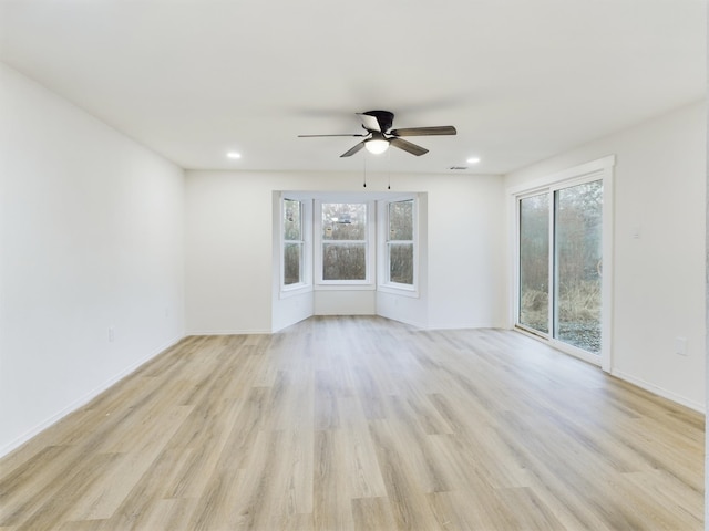 unfurnished room featuring ceiling fan and light wood-type flooring