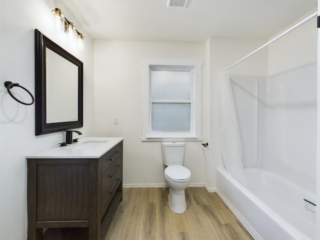 full bathroom featuring vanity, hardwood / wood-style floors, toilet, and shower / bath combo with shower curtain