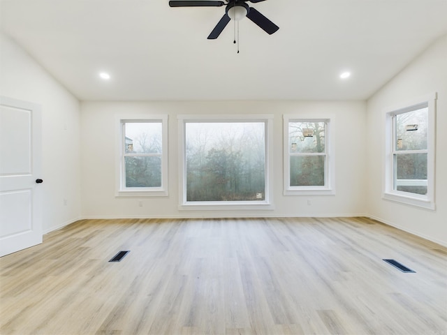 spare room featuring vaulted ceiling, ceiling fan, and light hardwood / wood-style floors