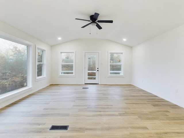 unfurnished living room featuring ceiling fan, lofted ceiling, and light hardwood / wood-style floors