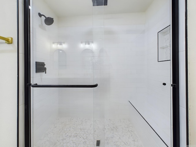 bathroom featuring a shower with shower door