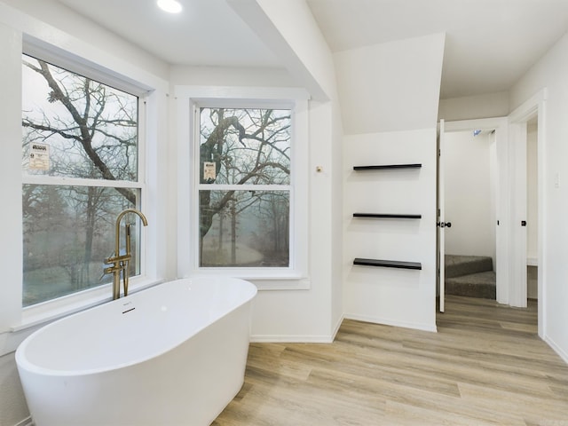 bathroom featuring wood-type flooring and a bathtub