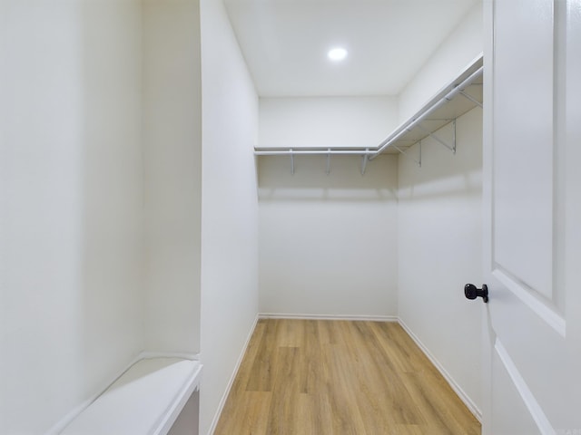 spacious closet with light hardwood / wood-style floors