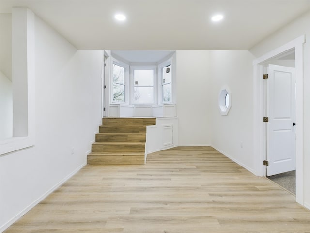 additional living space featuring light hardwood / wood-style floors