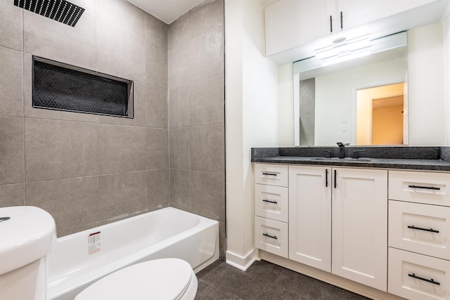 full bathroom featuring vanity, toilet, tiled shower / bath combo, and tile patterned flooring