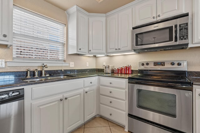 kitchen with white cabinetry, sink, dark stone countertops, and appliances with stainless steel finishes