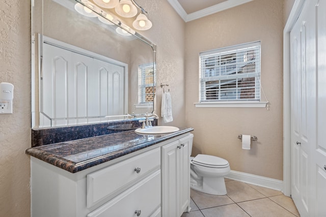 bathroom featuring vanity, ornamental molding, tile patterned floors, and a healthy amount of sunlight