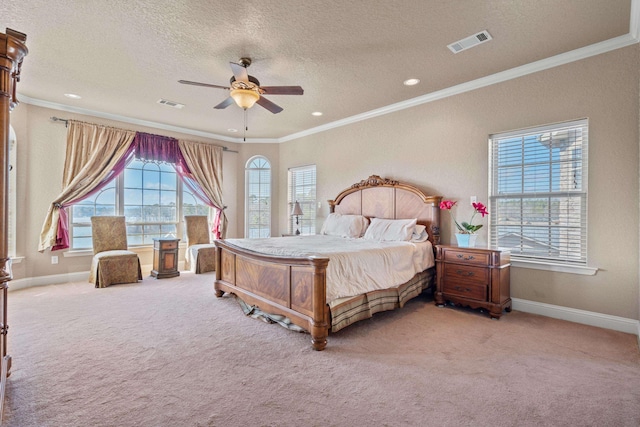 bedroom featuring ceiling fan, ornamental molding, a textured ceiling, and carpet flooring