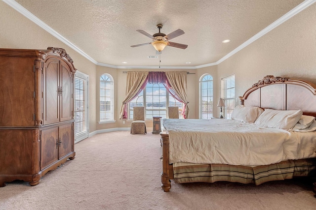 bedroom with ornamental molding, light colored carpet, ceiling fan, and a textured ceiling