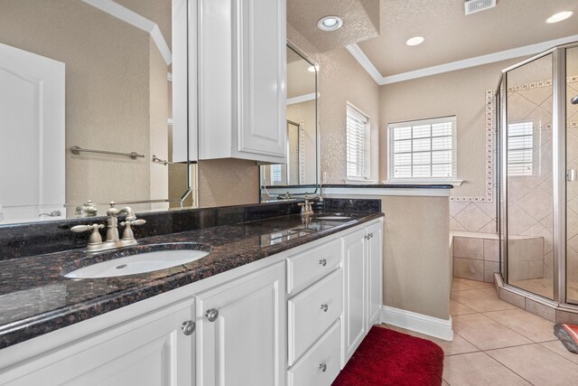 bathroom featuring vanity, an enclosed shower, crown molding, tile patterned floors, and a textured ceiling