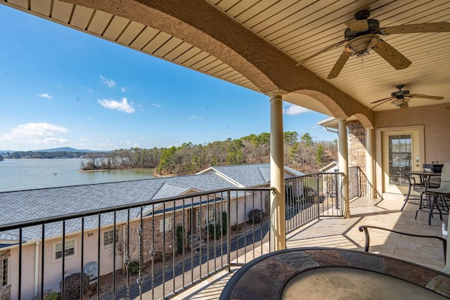 balcony with a water view and ceiling fan