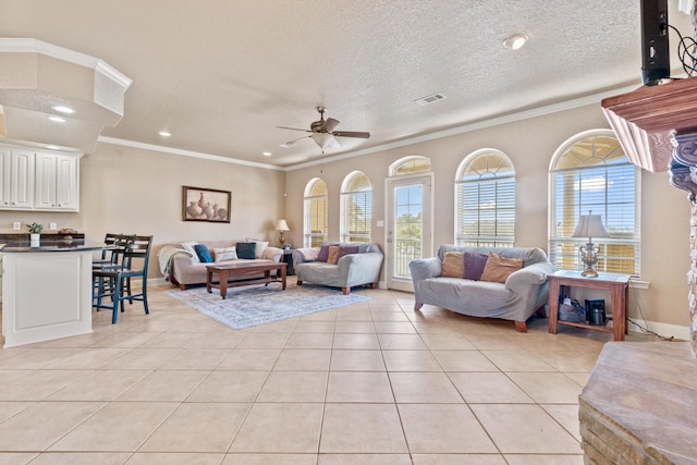 tiled living room with crown molding, ceiling fan, and a textured ceiling