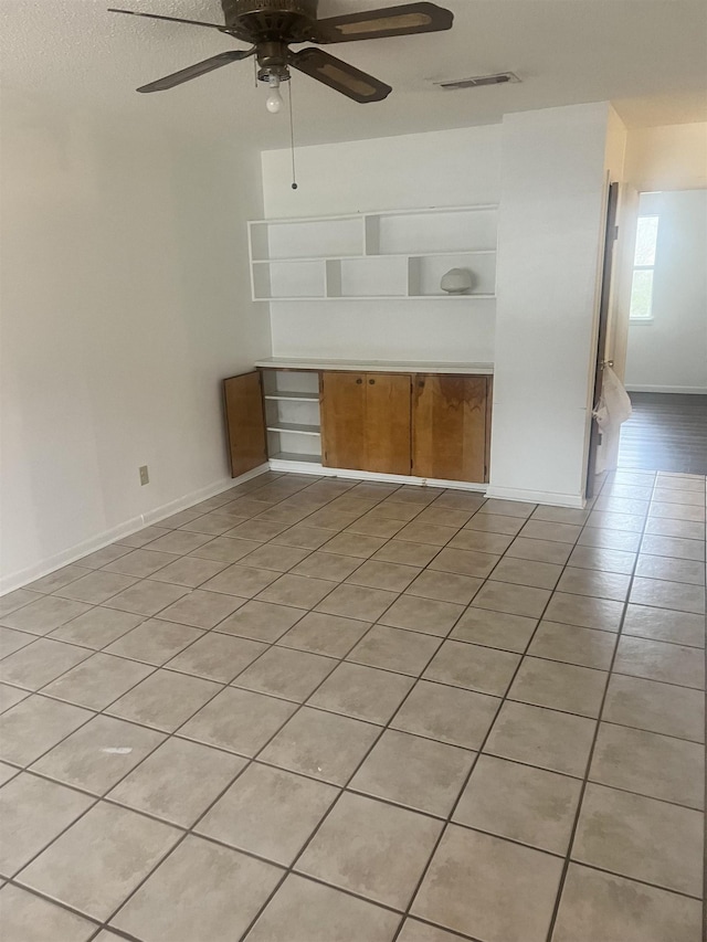 unfurnished living room featuring ceiling fan