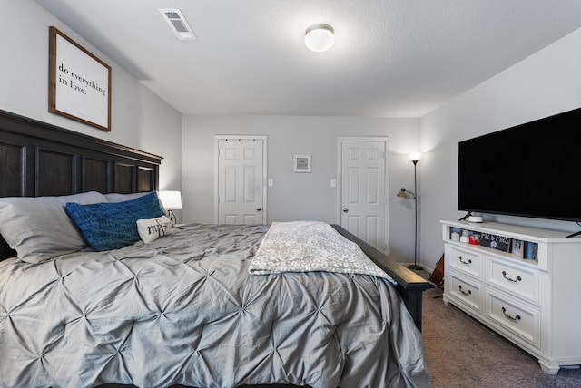 bedroom featuring dark colored carpet