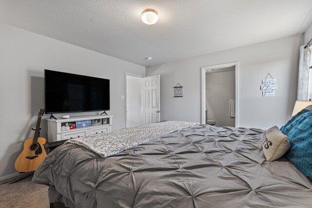 bedroom with carpet and a textured ceiling