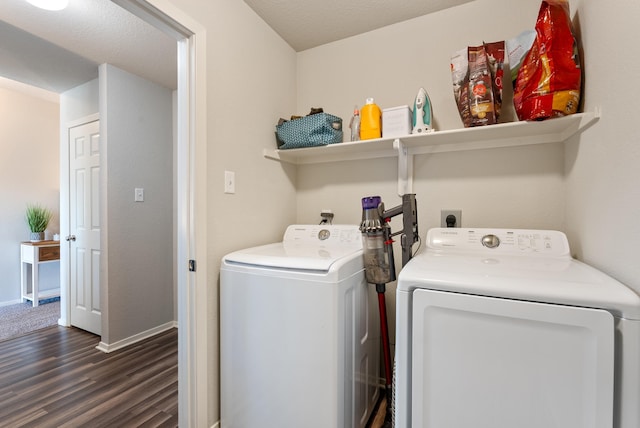 laundry area featuring washing machine and dryer and dark wood-type flooring