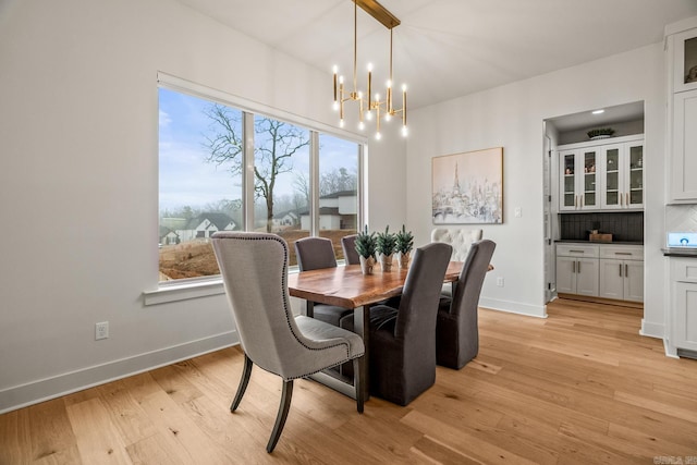 dining room featuring light hardwood / wood-style flooring and a notable chandelier