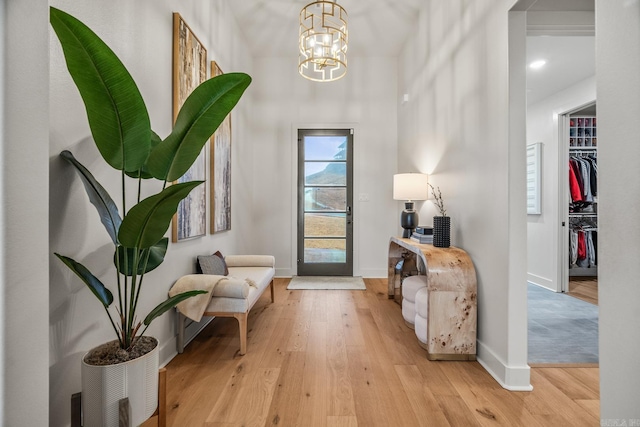 living area featuring a chandelier and light wood-type flooring