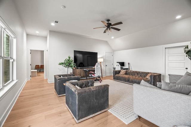 living room featuring lofted ceiling, light hardwood / wood-style flooring, and ceiling fan