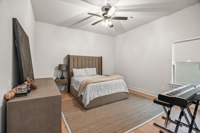 bedroom with hardwood / wood-style flooring and ceiling fan